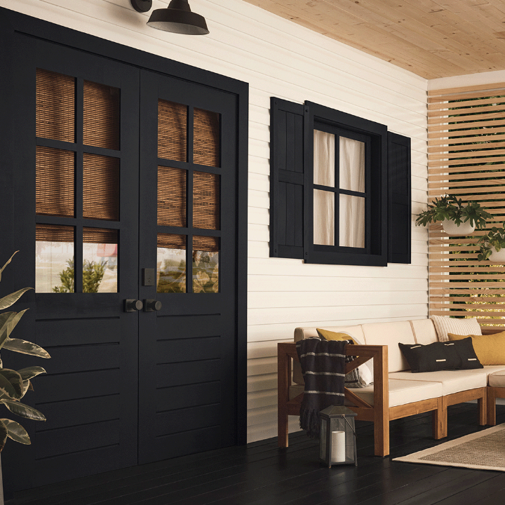 Enclosed porch living area, white siding, true black trim and floor.