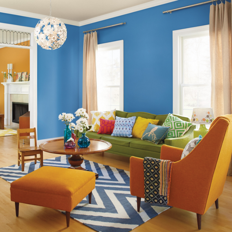 A living room adorned with retro modern furniture, walls painted Ship Shape Blue.
